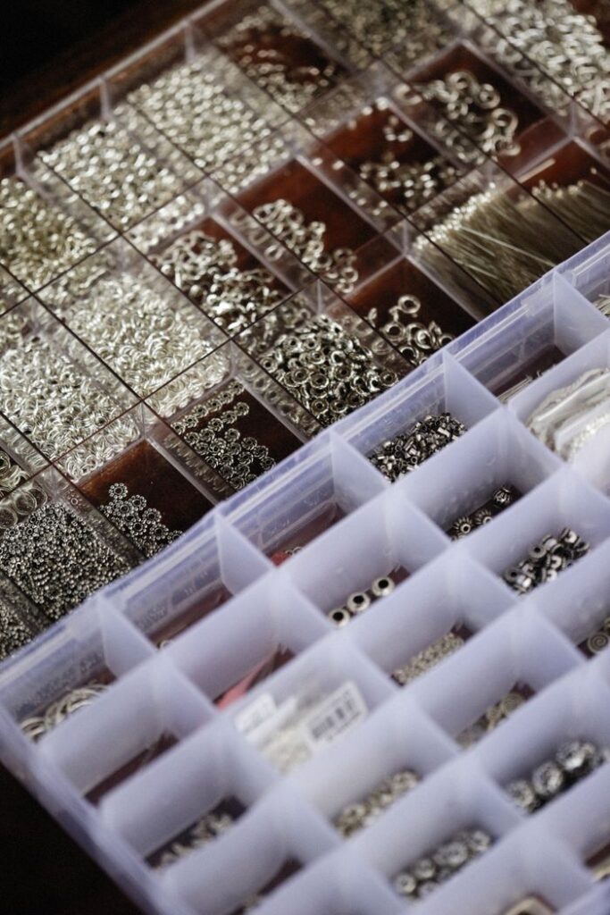 Close-up view of neatly organized jewelry findings in a storage box, perfect for crafting.