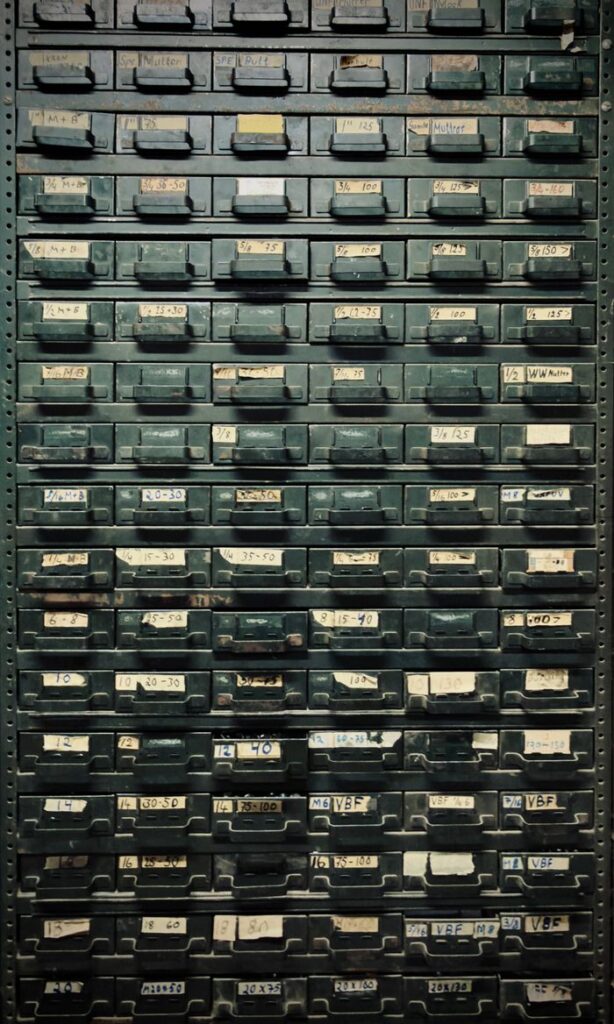 A vintage metal cabinet with labeled drawers, ideal for industrial-themed decor.