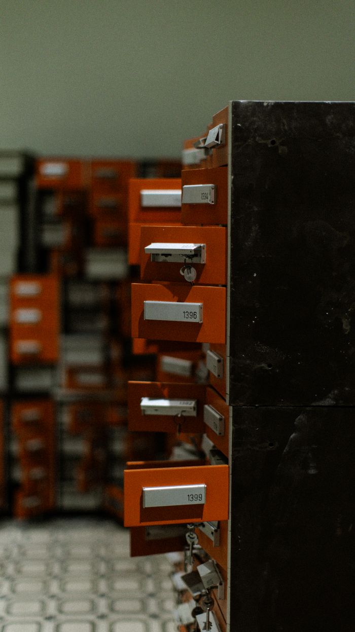 The Art of Drawing Readers In: Your attractive post title goes here A row of open orange metal lockers in a dimly lit indoor hallway, creating a moody industrial atmosphere.